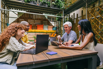 Group of Diverse Colleagues Collaborating in Cozy Patio Workspace