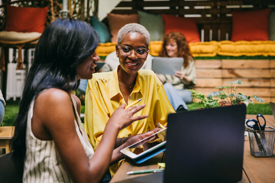 Collaborative discussion in modern workspace with happy professionals