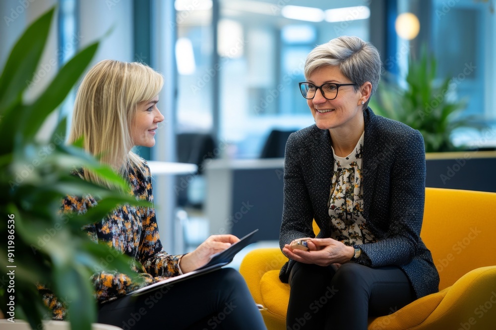 Wall mural senior businesswoman mentoring a young female colleague