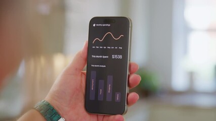 User reviews spending habits using a budgeting app on a smartphone. - Powered by Adobe