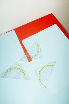 Set square rulers on business office desk and hard direct flashlight