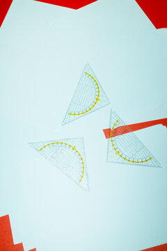 Set square rulers on business office desk and hard direct flashlight