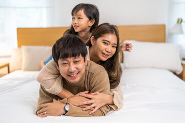 Portrait of enjoy happy love asian family father and mother holding hug cute little asian girl child smiling play and having fun moments good time, care, kid, support, insurance, child, at home