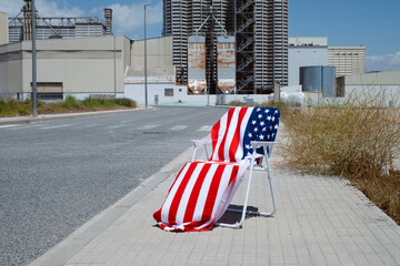 US flag towel on a chair in a lonely street