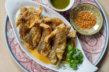 Fried sea bass with fish sauce, served with seafood sauce