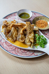 Fried sea bass with fish sauce, served with seafood sauce
