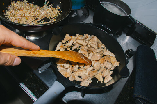 Cooking crispy fried chicken cubes in skillet