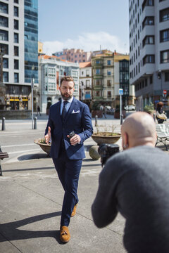 Videographer filming real estate agent outside