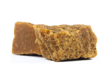 pieces of artisanal sugar cane panela on an isolated white background