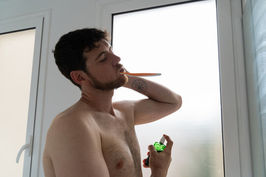 Man Applying Deodorant in Bathroom