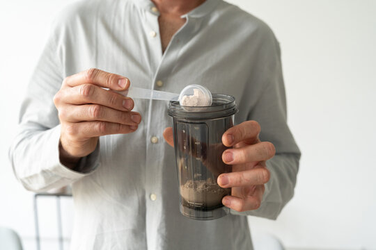 Man preparing protein shake at home