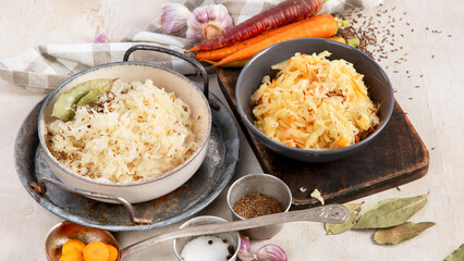 Winter salad on wooden light background. Homemade sauerkraut cabbage withcarrot. Tasty