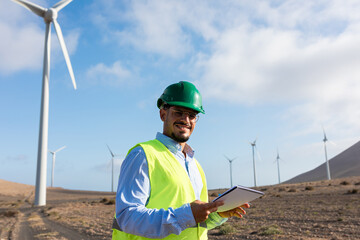 Portrait of a wind farm worker, dressed in safety clothing