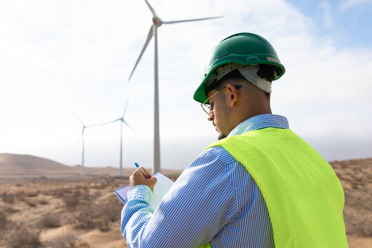 Professional energy worker uses a pen and notebook to make notes