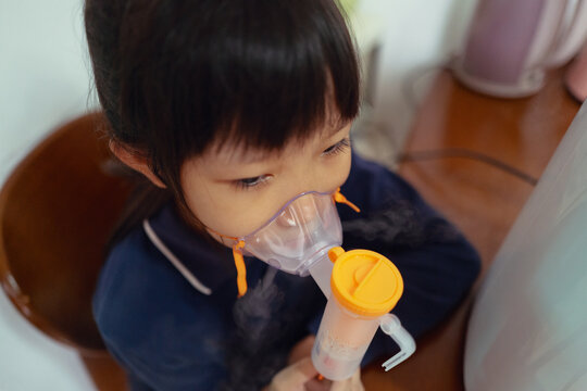 kid receives respiratory nebulizer treatment at home