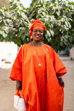 Senegalese woman smiling and wearing traditional clothes