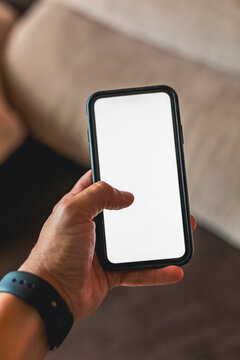 Hand holding smartphone with blank screen