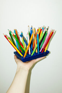 Colorful spike pencils on business office desk with hard flashlight