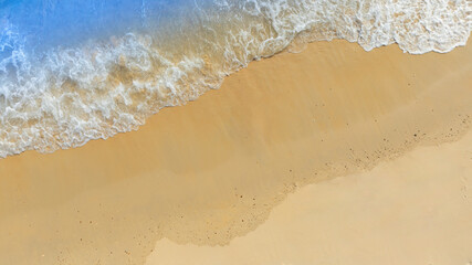 Top view beach sand background for summer vacation concept. Beach nature and summer seawater with sunlight light sandy beach Sparkling sea water	