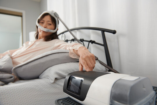 Sleep Apnea:  Asian Woman Starts CPAP Machine 