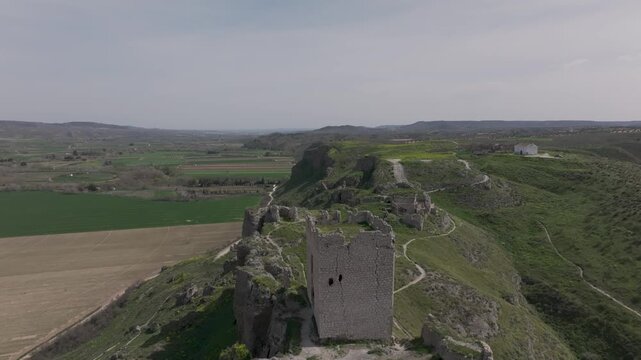Drone flight over the cliff where we see the castle of Oreja located on one side of the ravine, ruins of an old structure appear and on the other the depopulated area of ​​Oreja and its hermitage