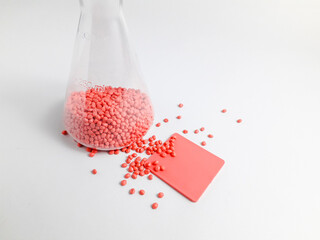 Soft pink masterbatch granules in erlenmeyer flask isolated on white background.Color pigment...