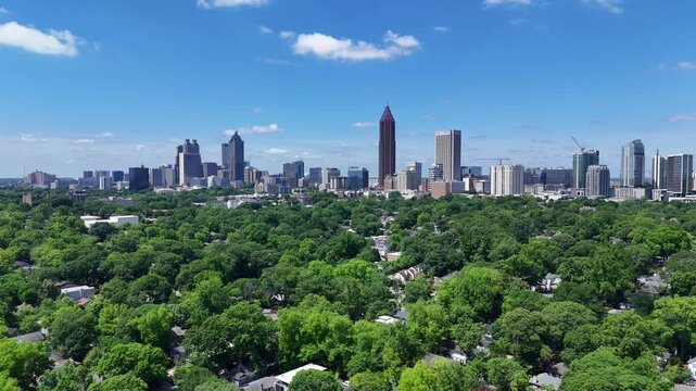 Drone shot pushing in on an Atlanta, Georgia skyline during the day.