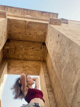 Young Woman Posing Under Ancient Egyptian Temple Archway