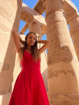 Woman in Red Dress Posing at Ancient Egyptian Temple