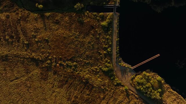 Eshbrack, County Monaghan, Ireland, September 2022. Drone in Bird's Eye view tracks north east parallel with Lough Antrawer over wild marshy boglands on a warm Autumn evening.