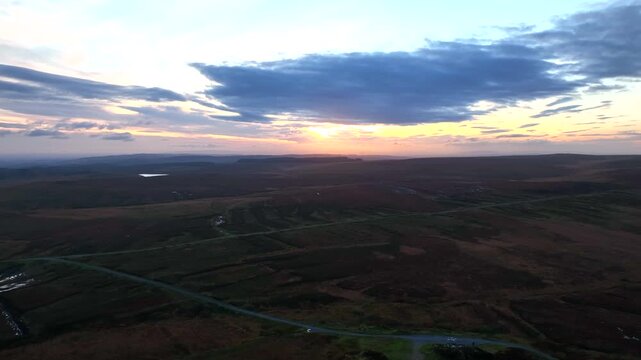 Sliabh Beagh, County Monaghan, Ireland, November 2022. Drone pulls east while ascending over the wild bog during a winter sunset over Eshbrack with Lough Antrawer and Lough Aportan in the distance.