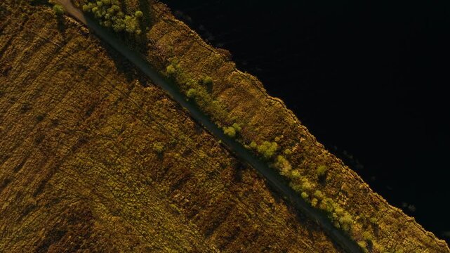 Eshbrack, County Monaghan, Ireland, September 2022. Drone in Bird's Eye view tracks south west above Lough Antrawer and wild marshy wetlands on a warm Autumn evening.