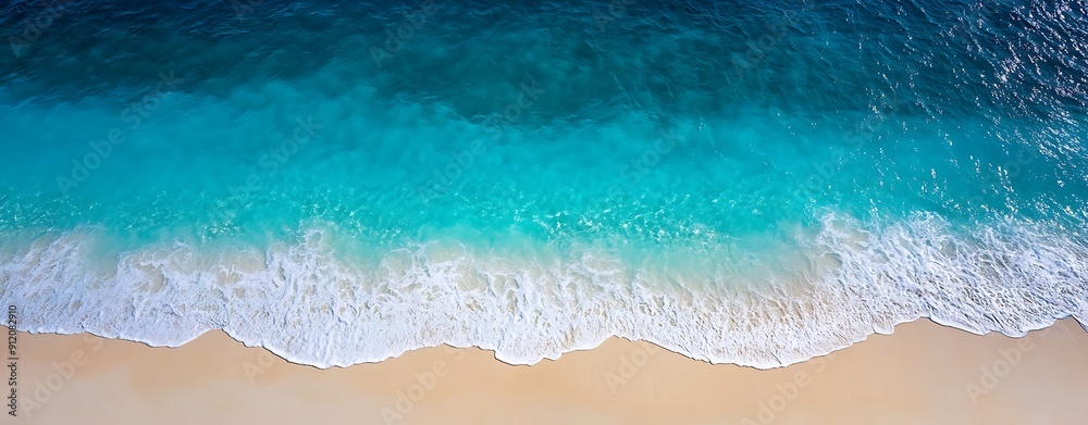 Wall mural aerial view of a beach with turquoise waters, waves gently lapping, nature background with copy spac