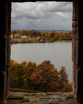 Scenic view of lake framed by a castle window