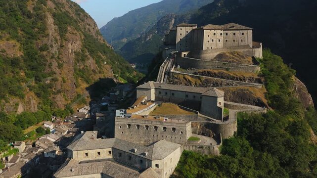 Fort Bard in Aosta Valley, Italy, seen from above, surrounded by lush mountains and historic architecture
