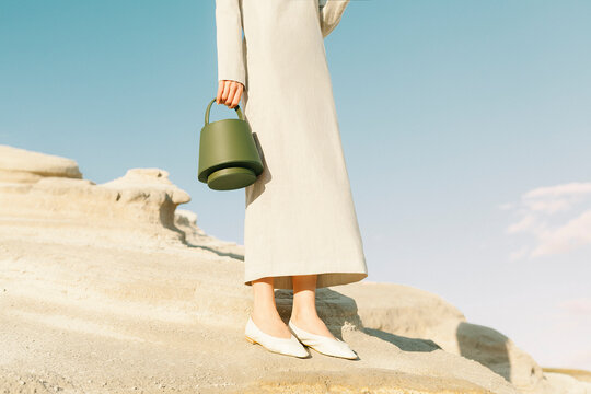 Elegant Woman Holding Green Handbag Outdoors
