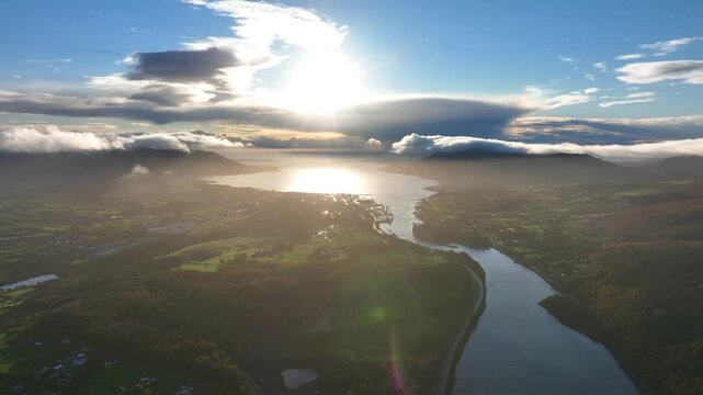 Flagstaff, County Down, Northern Ireland, November 2022. Drone pushes south east above the Newry river towards Warrenpoint as dawn breaks with clouds rolling over Carlingford Lough and Slieve Foye.