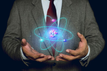 Bussinessman hand holding creative atom. Nuclear fusion concept, endless energy, cheap electricity,...