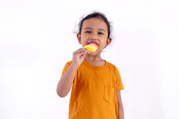 A happy little Asian girl enjoying an ice cream, on a white background