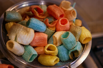 Close up view fried crunchy colorful Indian tubular snacks.