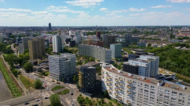 Modern buildings along Loire River near Pont Eric Tabarly bridge, Nantes in France. Aerial drone backward