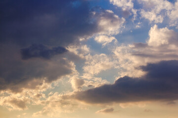 dramatic dusk. dynamic clouds on the sky in golden light above the horizon. summer holidays rainy weather forecast