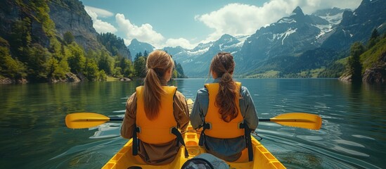 Two Women Kayaking in a Scenic Mountain Lake