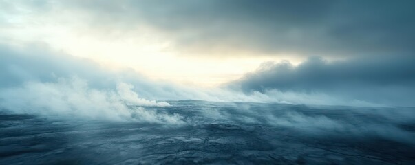 Obraz premium Aerial view of a vast, ethereal landscape shrouded in mist and clouds, with a bright light filtering through.