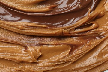 Tasty peanut butter as background, top view