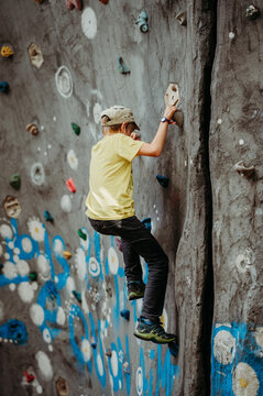 Boy climbing a wall in Wallis, Switzerland