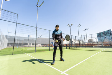 paddle tennis coach teaching on a residential paddle court, front view