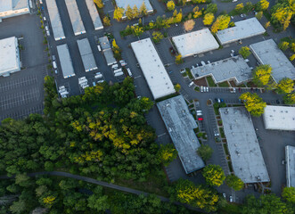 A view of a parking lot with a lot of white buildings in the background