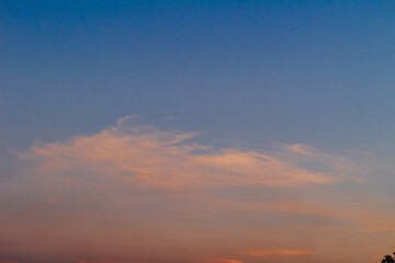 Fototapeta premium Dramatic clouds in the blue sky in the morning, the rising sun rays hitting the clouds