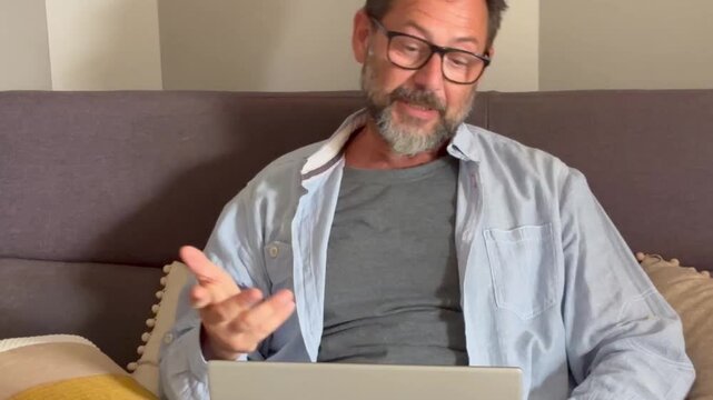 Man sit on desk in living room look at laptop screen start conversation use videocall app. E-employment, pass job interview remotely, business solutions via videoconference start up small business